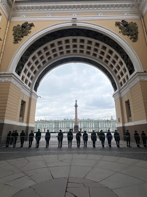 Tourist documents Palace Square architecture during overcast afternoon