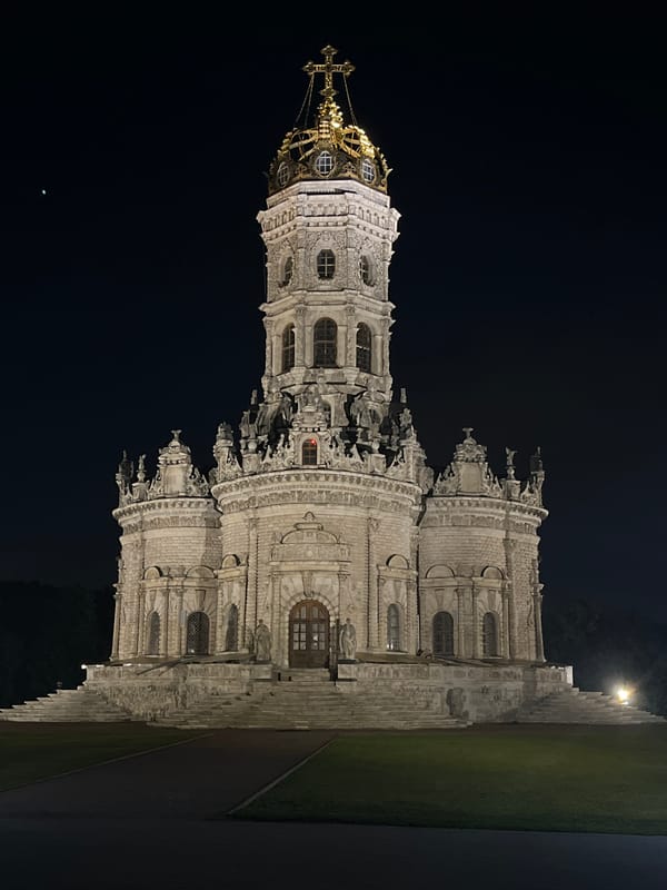 Nighttime stroll through lit baroque architecture and park paths