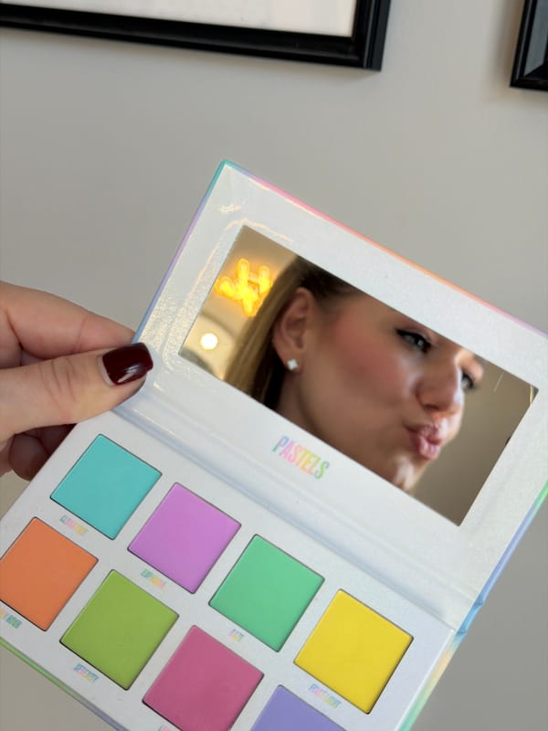 Woman applies lipstick in Riga beauty routine moment