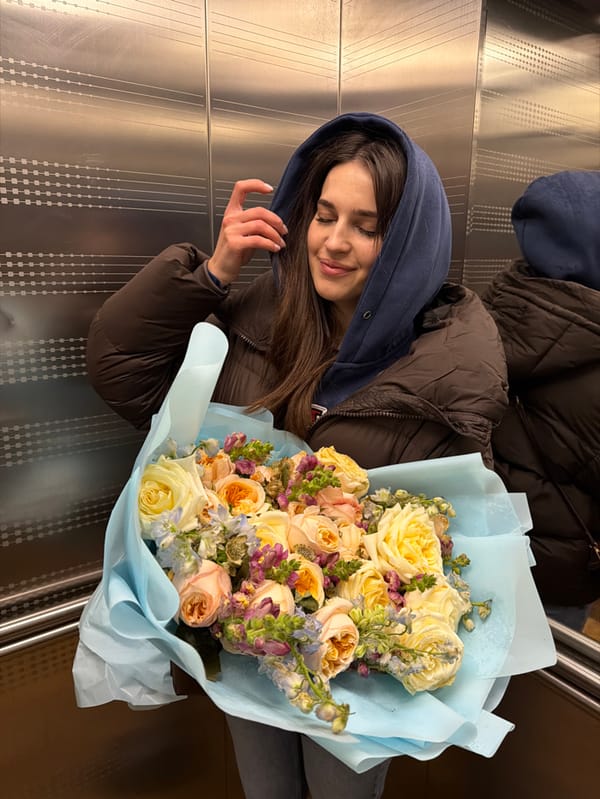 Women photographed with flowers, selfies in snowy Moscow afternoon