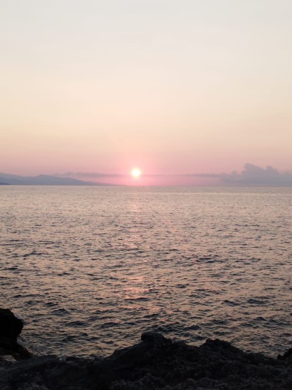 Sunset over the rocky Antibes coastline, July evening.