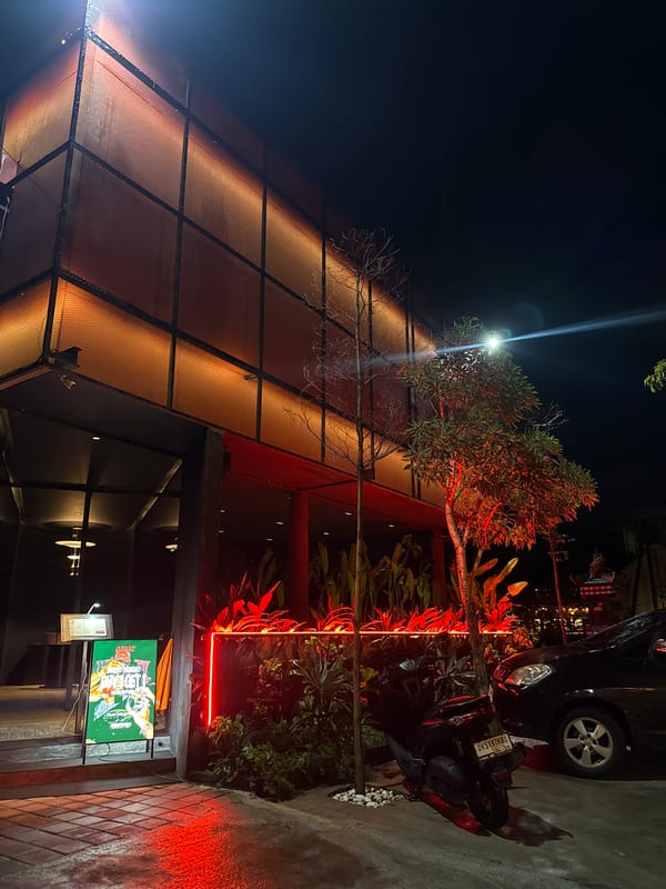 Nighttime documentation of commercial district with shrine and motorcycles