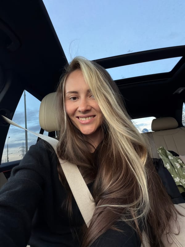 Woman photographed smiling in car on Moscow highway