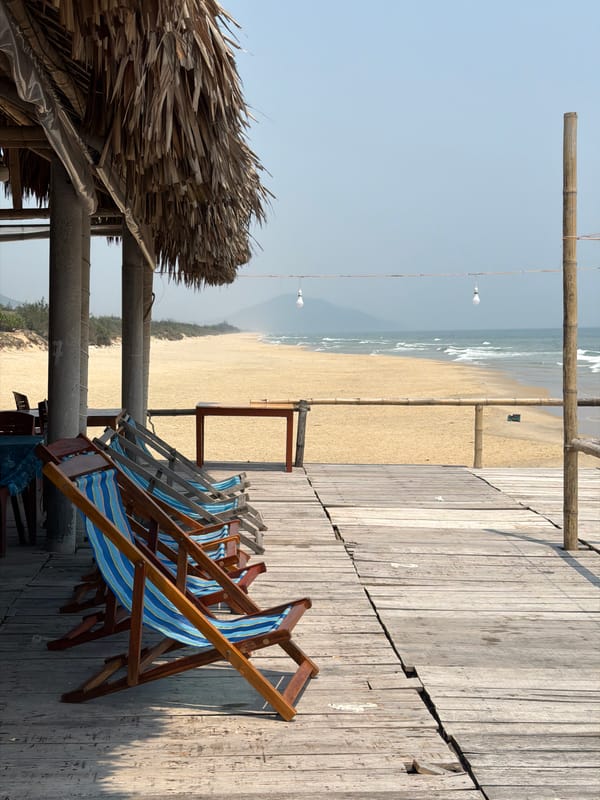 Beachside cafe with striped chairs documented in Huế, Vietnam