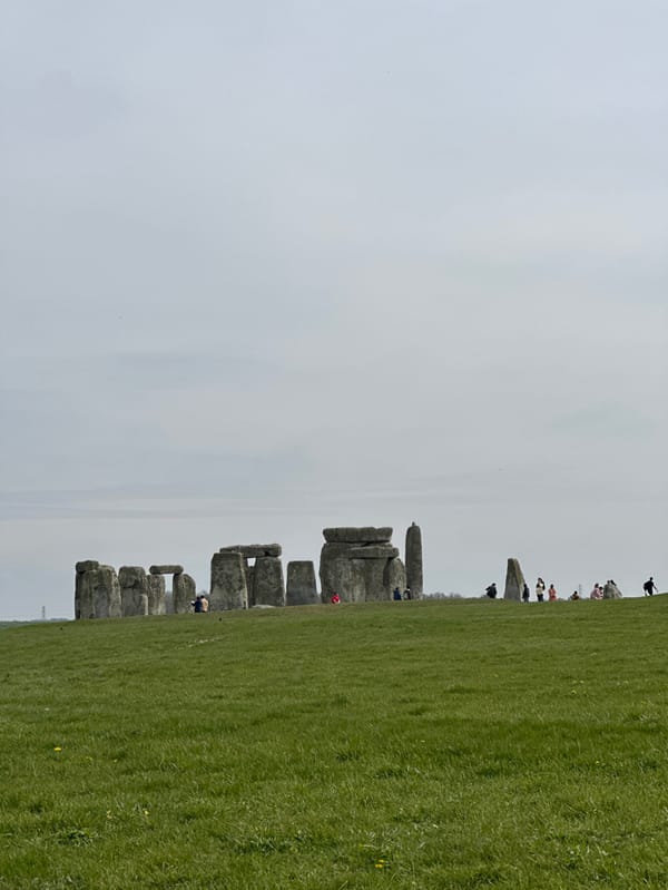 Family visits Stonehenge on overcast March afternoon