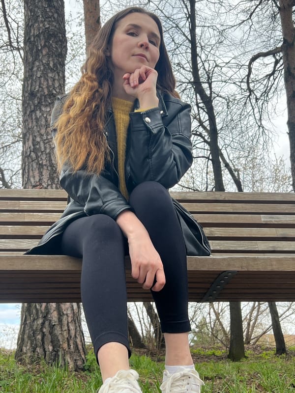 Woman rests on park bench in Votkinsk, Russia