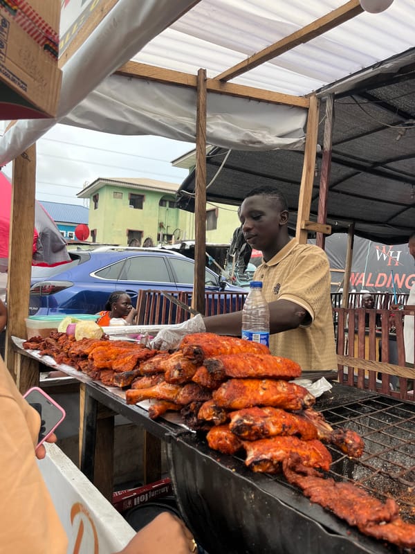 Street food vendors serve customers in Ado, Nigeria