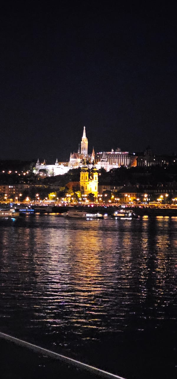 Danube River at night, Buda Castle District glowing behind it
