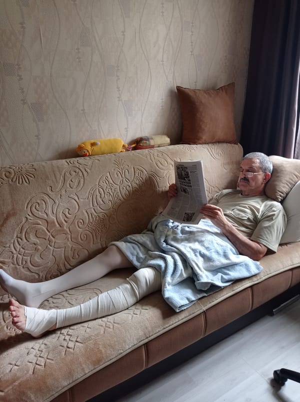 Reading the news at home, leg bandaged, Degtyarsk