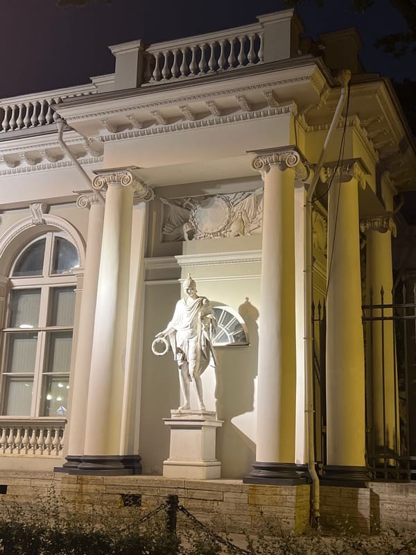 Nevsky Prospekt at night: Singer House and a classical statue