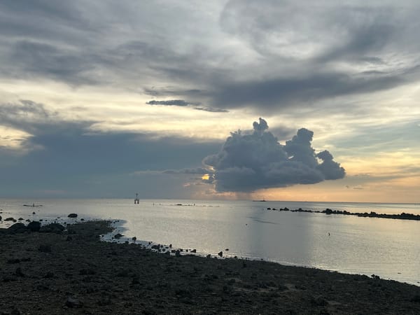 Twilight coastal scene documented at Thai beach with dramatic clouds