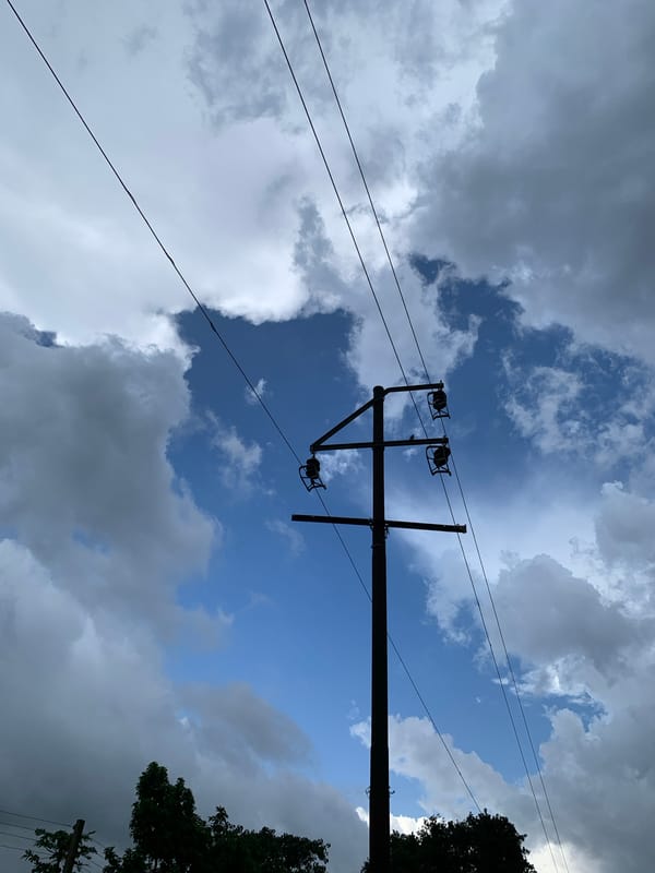 Storm clouds gather over Kuru Karama as harvest produce sits nearby