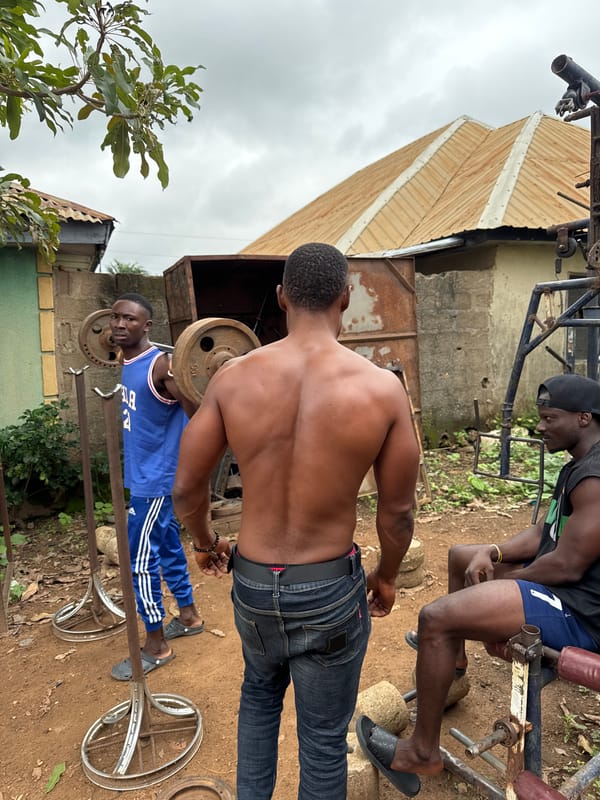 Outdoor barbell training in a makeshift backyard gym setup.