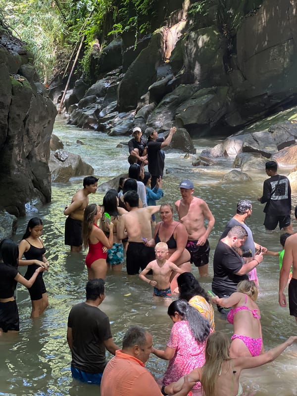 Large group enjoys waterfall swimming in Gianyar jungle