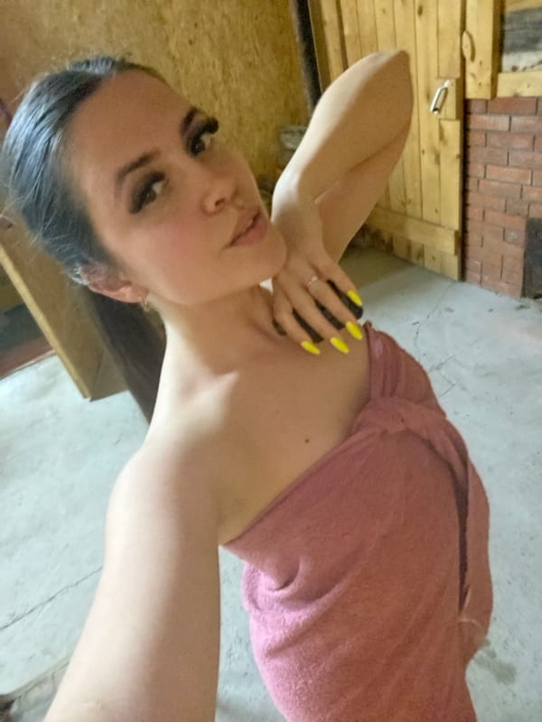 Woman photographed in pink towel in Zhigalki interior space