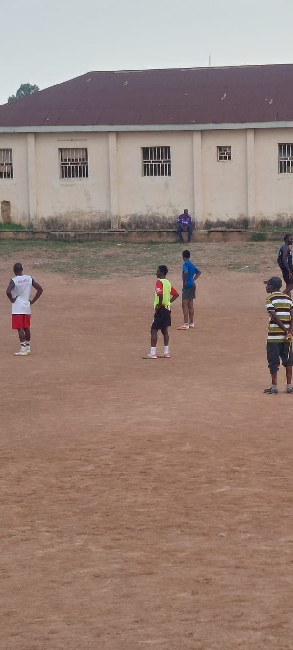 Soccer on a dusty pitch at Bukuru Stadium, Nigeria