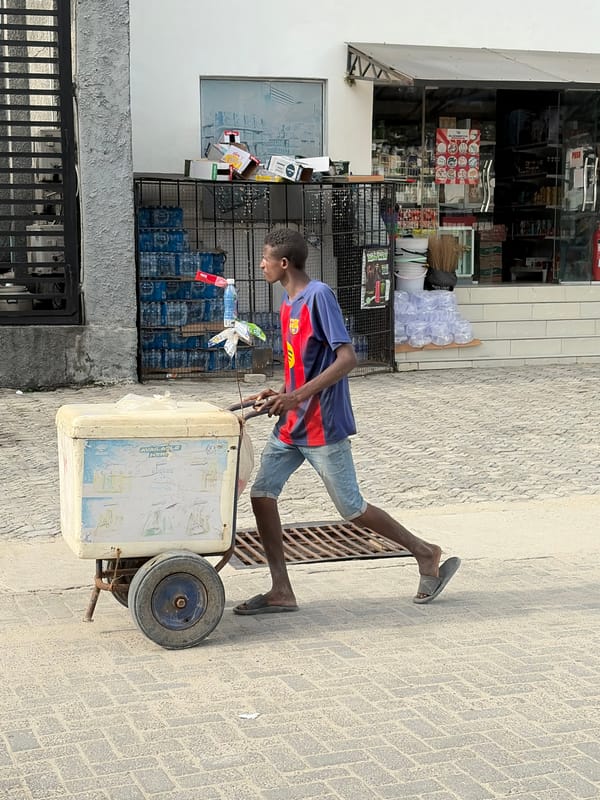 DHL van parks as man carries bamboo poles in Igboefon