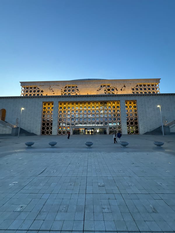 Moscow concert hall area documented with sculptures, unicyclist, architecture