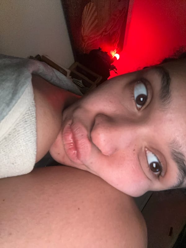 Woman takes indoor selfie with towel in London