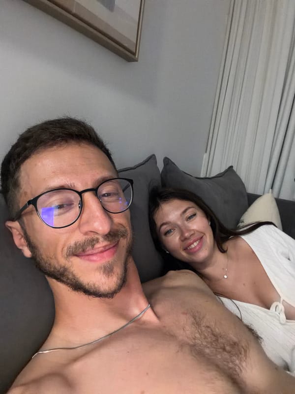 Couple takes selfie on couch in Tel Aviv