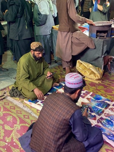Nighttime street market bustles with activity in Kandahar