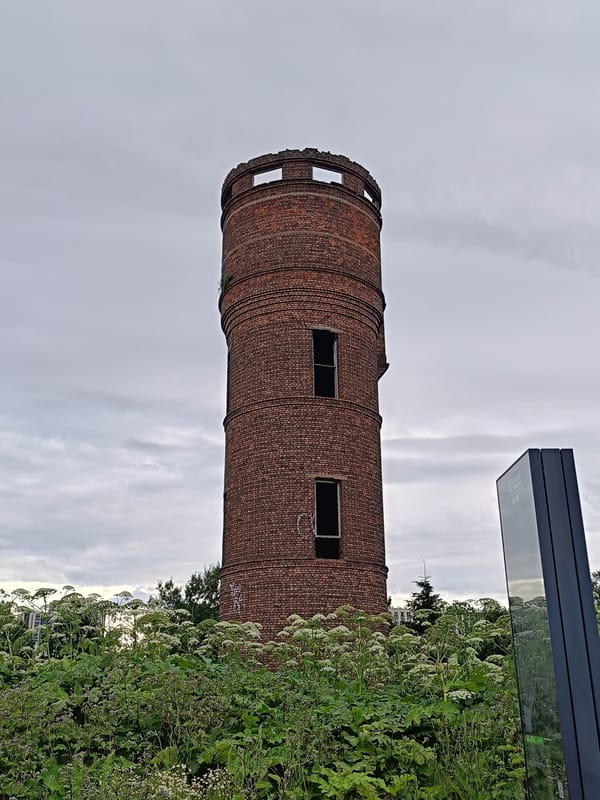 Old brick tower and war memorial cemetery in Saint Petersburg