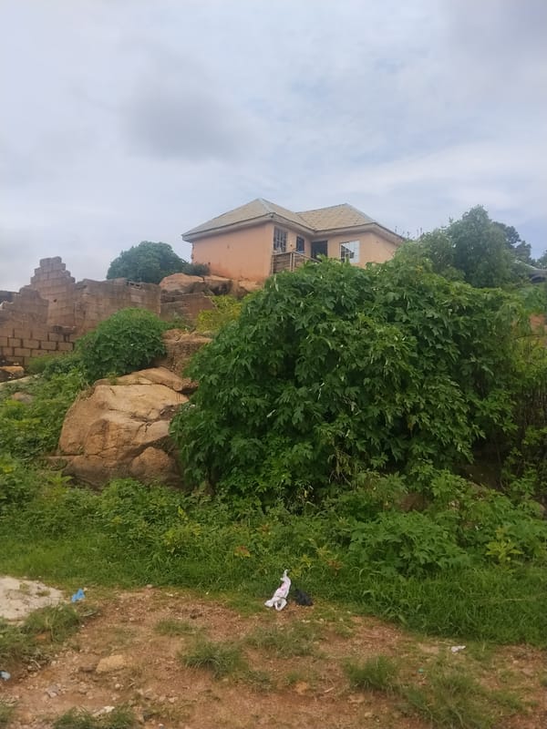 Jos hillside neighborhood: construction, rocky terrain, overcast skies