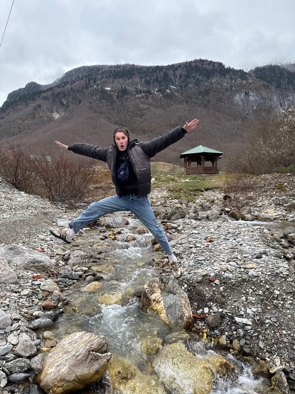 Tourists pose and film at Vusanje waterfall in Montenegro