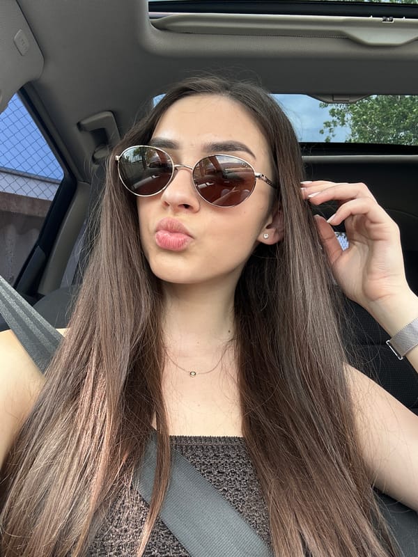 Woman with sunglasses spotted in vehicle passenger seat