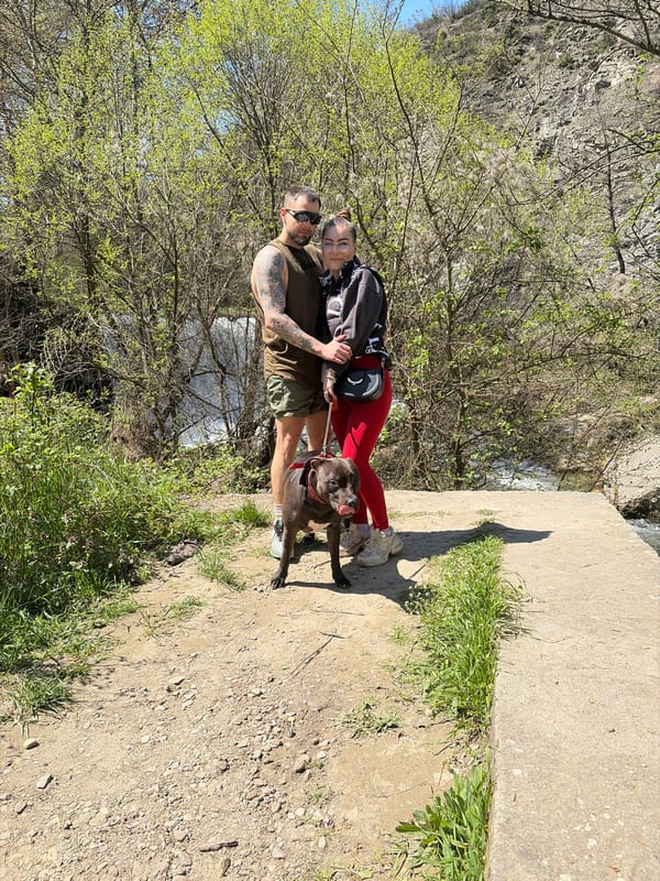 Couple explores scenic ravine area with dog in Parvenets