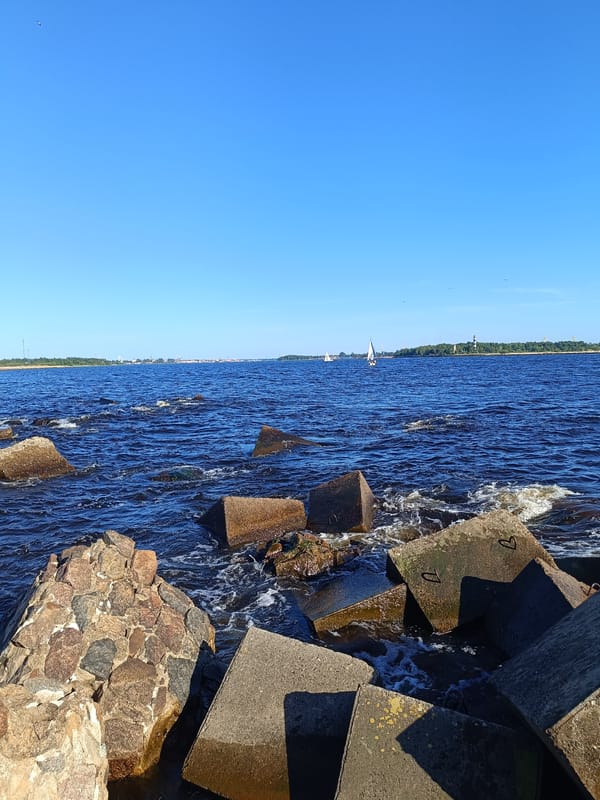 Sailing, fishing, and shoreline scenes at Riga's breakwater