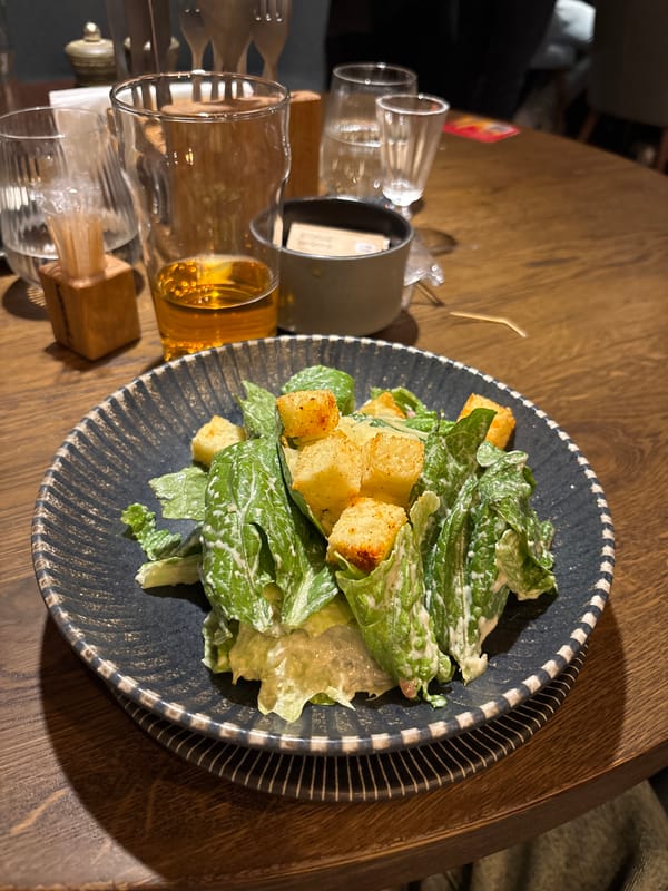 Restaurant worker serves Caesar salad in Engels, Russia