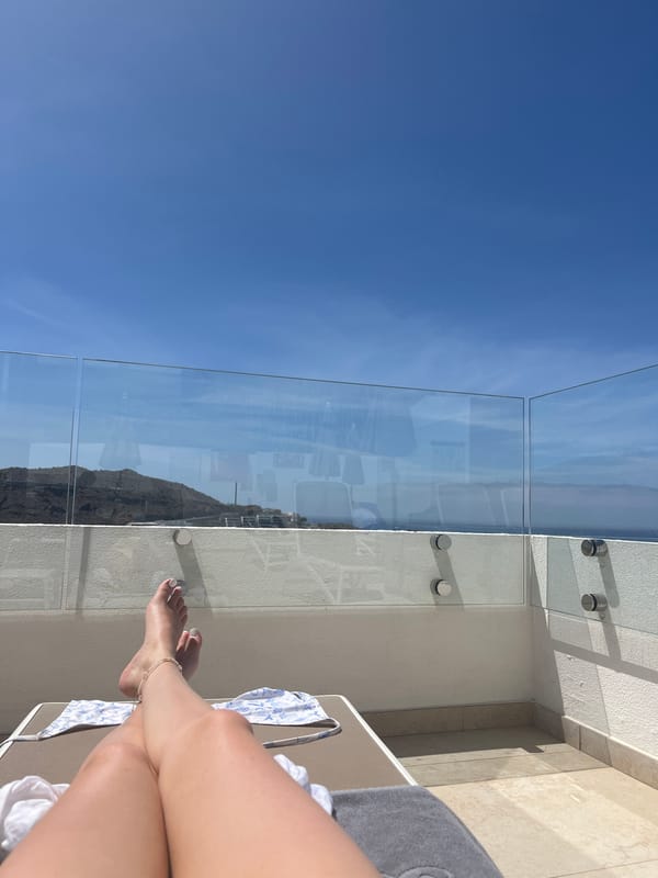Person relaxes on ocean-view balcony in Puerto Rico, Spain