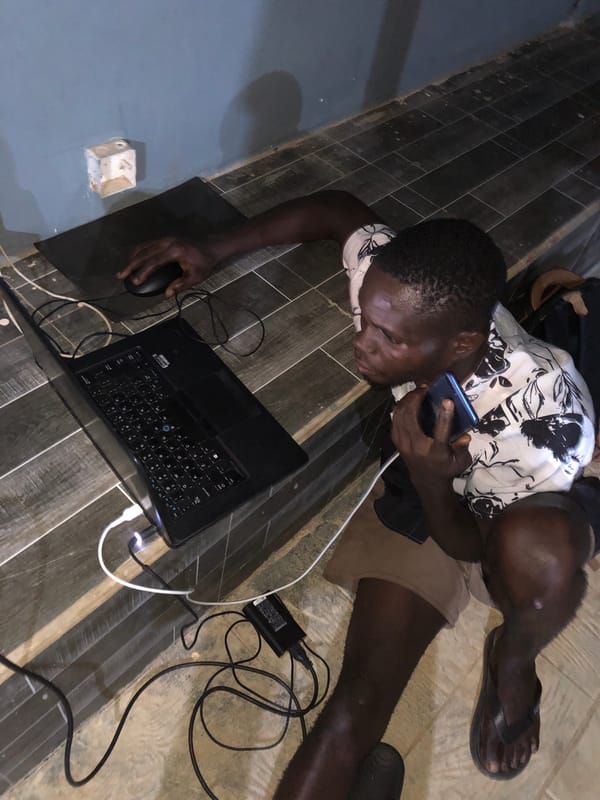 People using phones and laptops on tiled floors