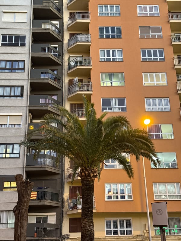 Multi-story building with orange stucco photographed in Palma