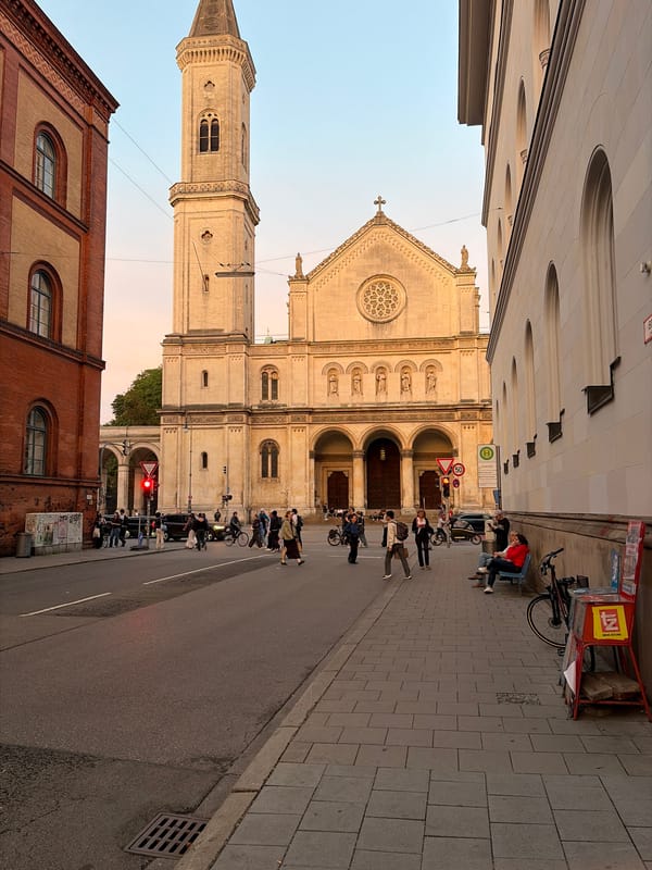 Munich street at golden hour, church and city buildings