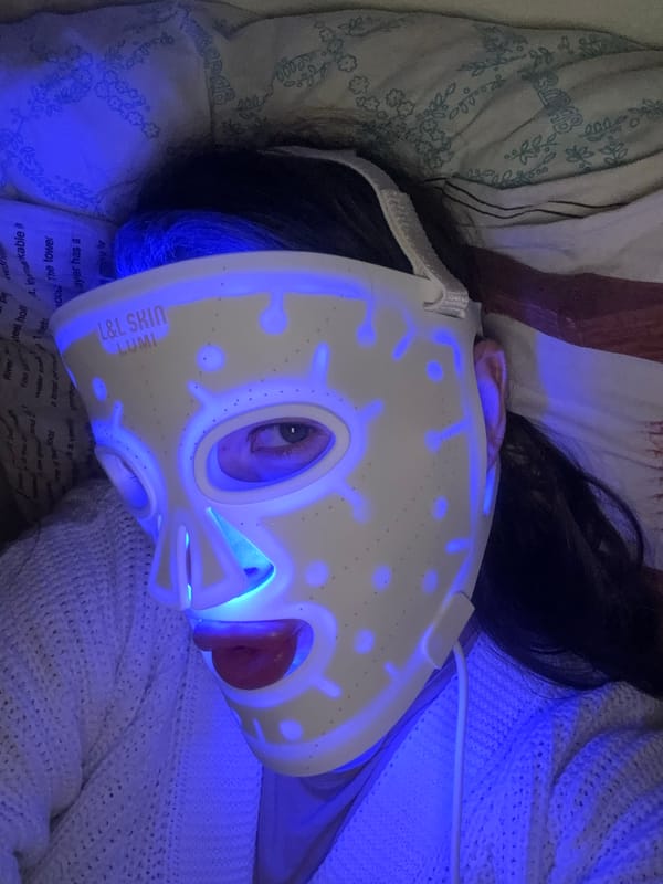 Woman rests in bed with tea during evening hours