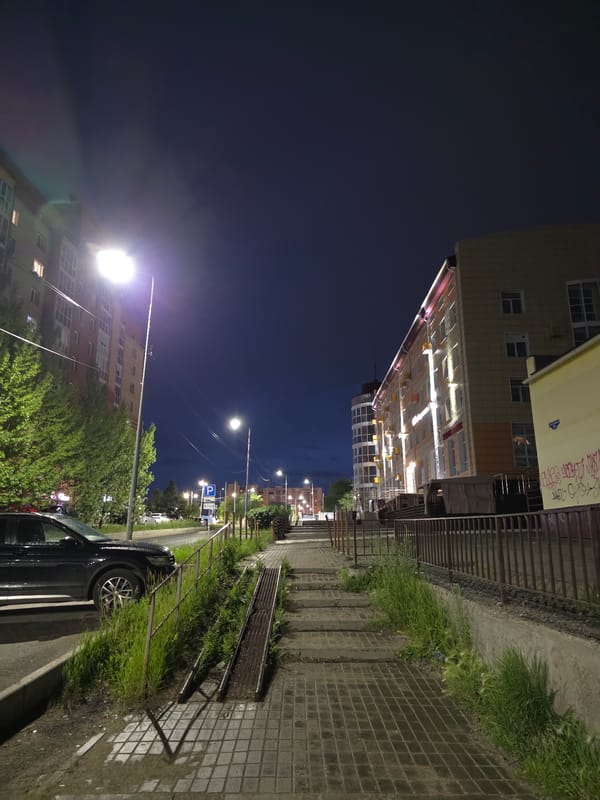 Omsk streets and buildings on a rainy summer night