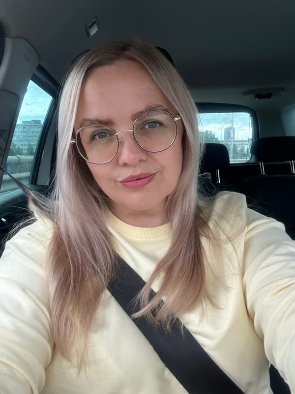 Passenger seat snapshots near a mural-covered building in Vologda