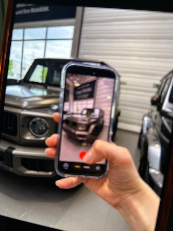 Person photographs Mercedes G-Class at German dealership