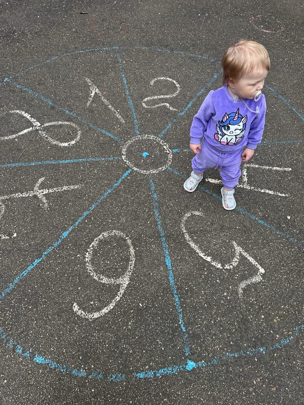 Child stands on chalk clock drawing in Nizhny Novgorod