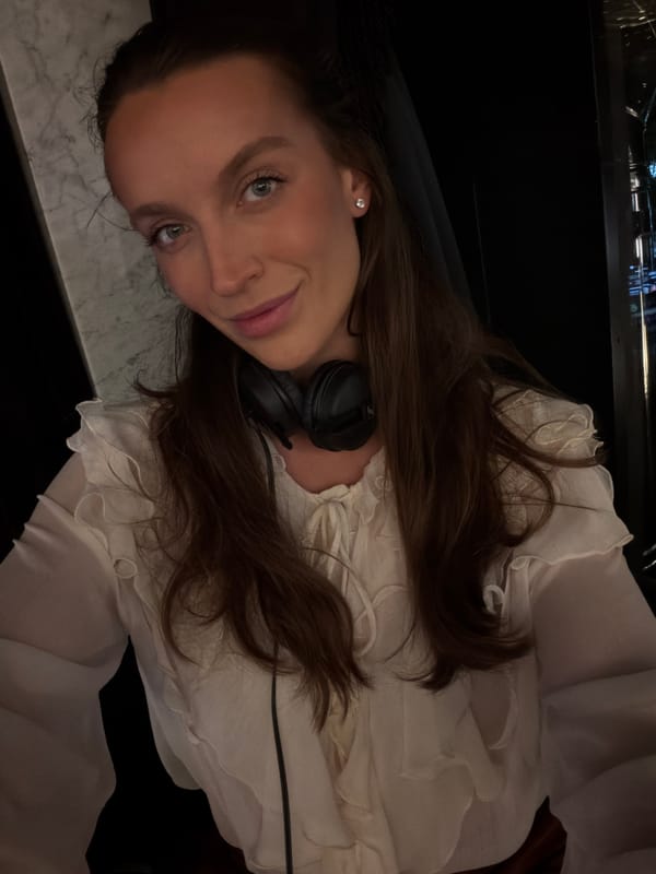 Woman photographed indoors wearing headphones in Budva, Montenegro