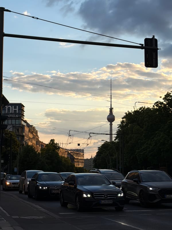 Berlin street scene captures TV Tower at sunset