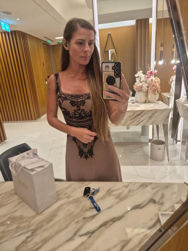 Woman takes mirror selfies in upscale indoor setting
