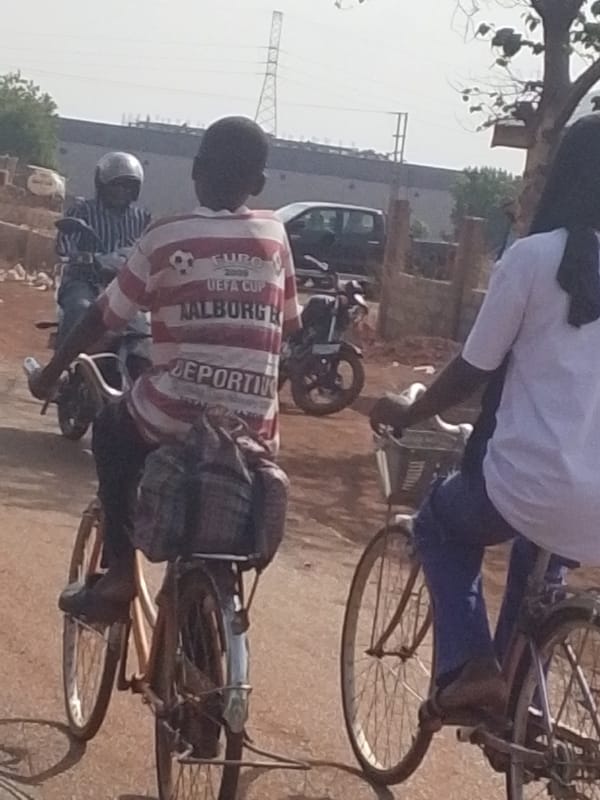 Three people observed in motion during outdoor daytime scene