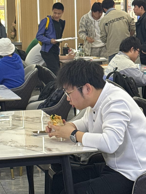Young people gather in modern Zhongtun mall during morning hours