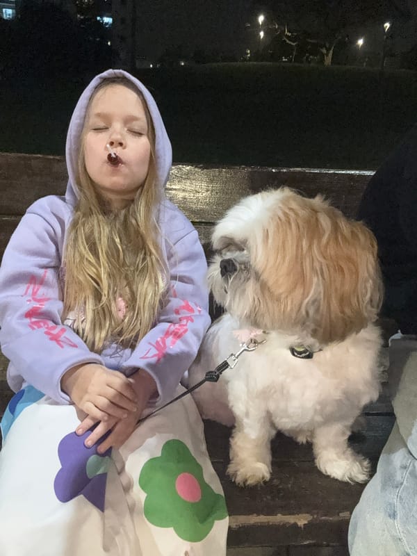 Dog owner and Shih Tzu enjoy park time in Bat Yam