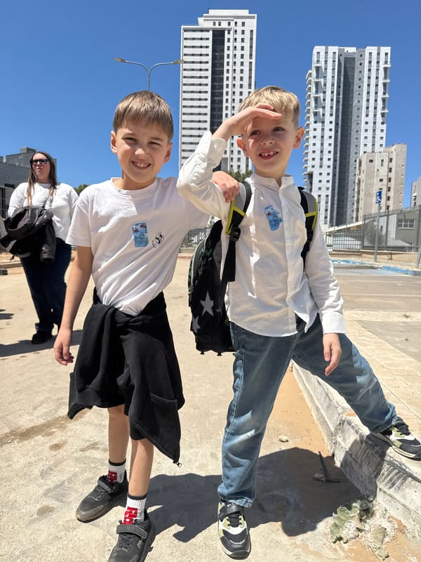 Two boys smile for camera in sunny Netanya