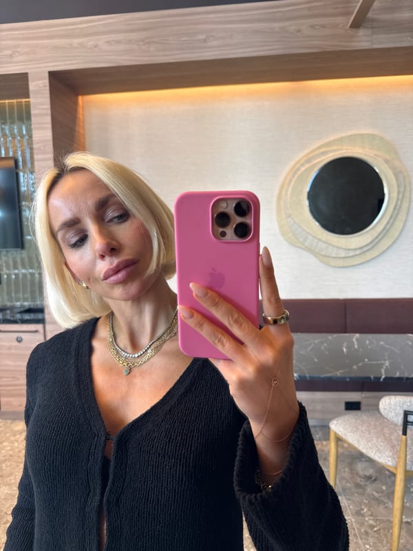 Woman takes mirror selfies with pink iPhone in San Diego