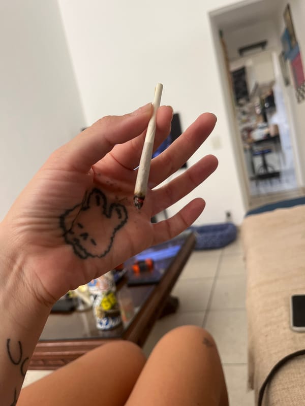 Person with rabbit tattoo photographed smoking indoors in Rio